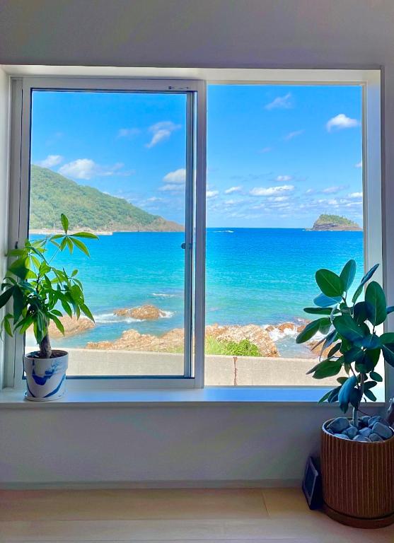 a window with a view of the ocean at SEABASE villa at shimane in Matsue