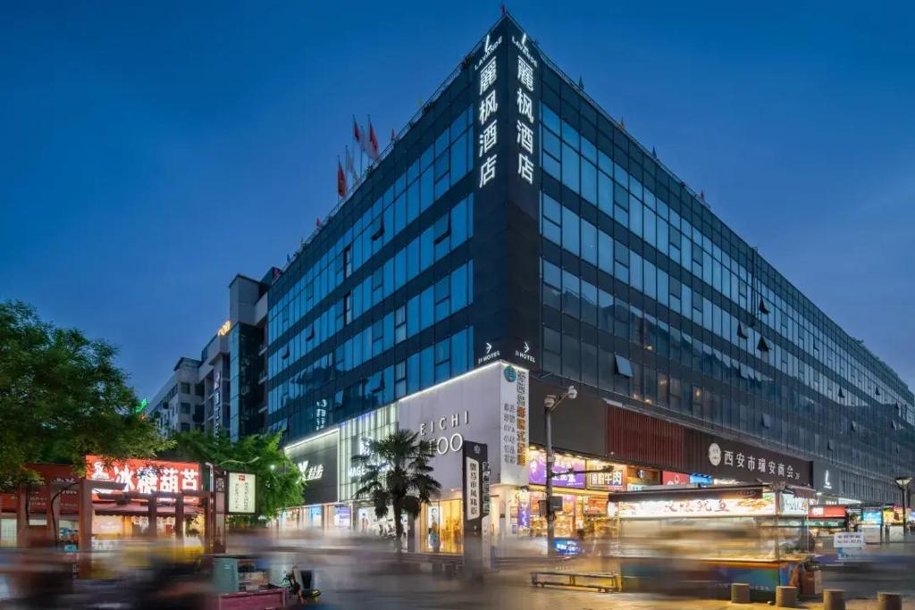 a large building on a city street at night at Lavande Hotel Xi'an Bell Tower in Xi'an