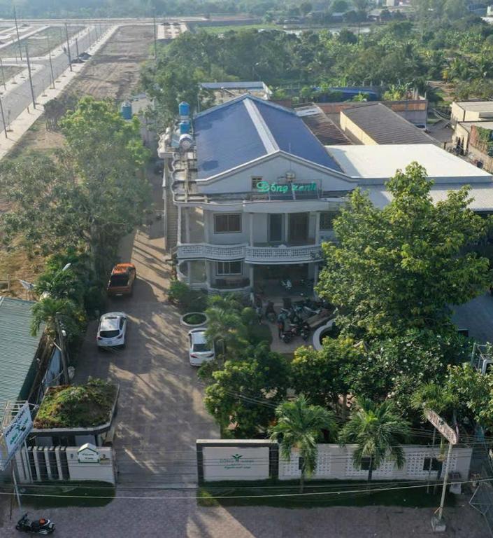 a building with a car parked in a parking lot at Dong Xanh Hotel in Chau Doc