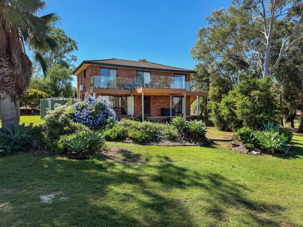 a house with a garden in front of it at Hunter Homestead & Cottage in Lovedale