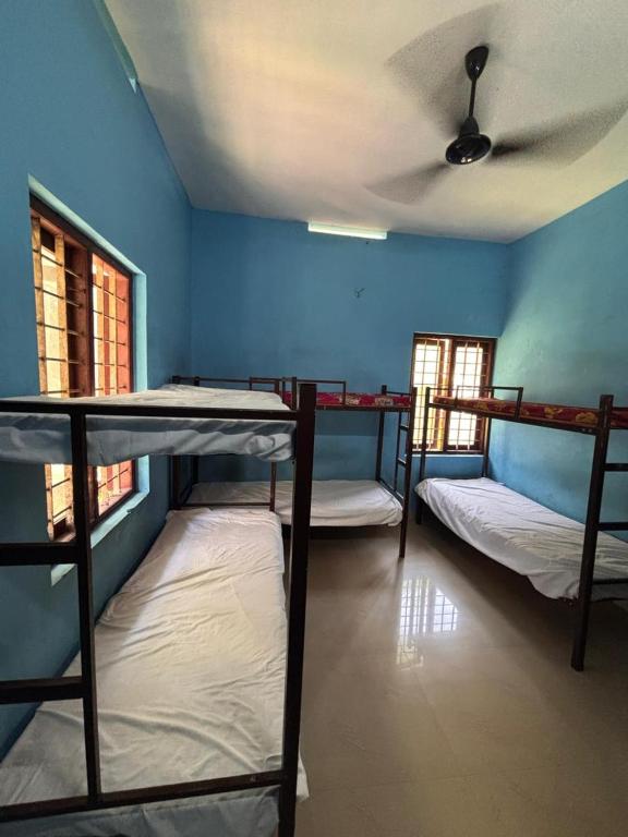 a room with three bunk beds and a ceiling at CK Enclave in Jāmb