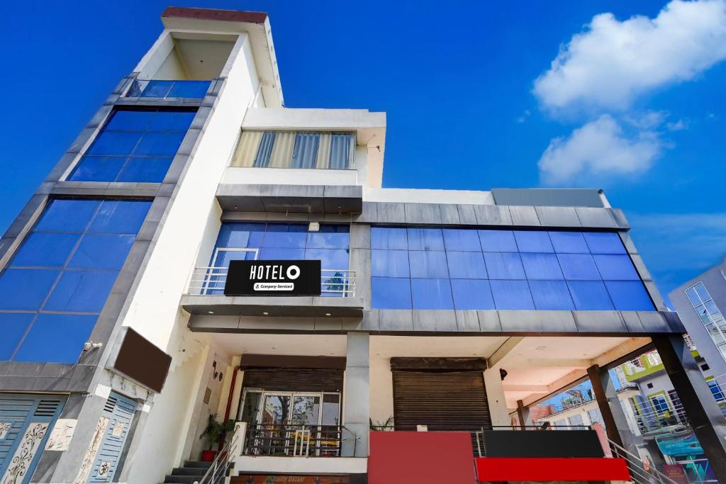 a tall building with a sign on it at Super OYO Hotel O Khargapur Ring Road Formerly Shimla Grand in Lucknow