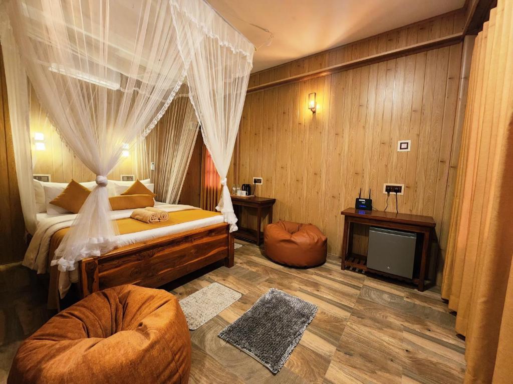 a bedroom with a bed and a tv in it at Tea Brook Lodge Ella in Ella
