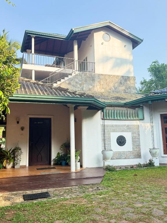 a house with a balcony on top of it at Hillcrest Bungalow in Matale