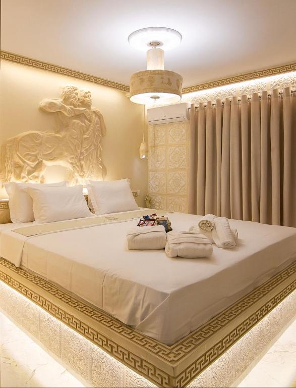 a bedroom with a large bed with towels on it at CENTAURIA Greek Luxury Suite 5' Port Gate 7-8 & Cruises Gate 11-12 in Piraeus