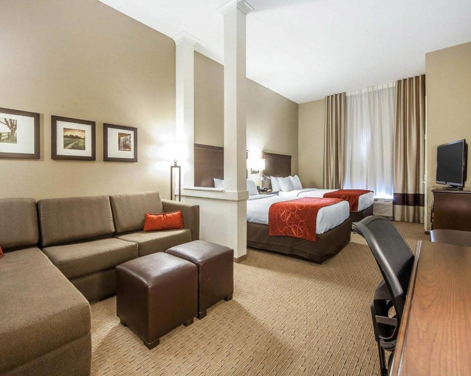 a hotel room with a bed and a couch at Comfort Suites Marietta-Parkersburg in Marietta