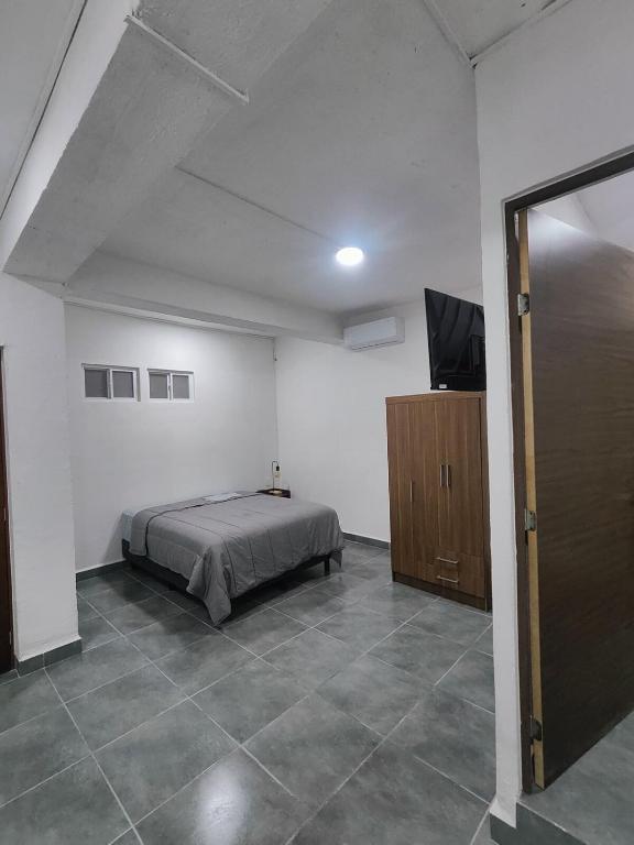 a bedroom with a bed and a flat screen tv at Freya studio III Romantic Zone in Puerto Vallarta