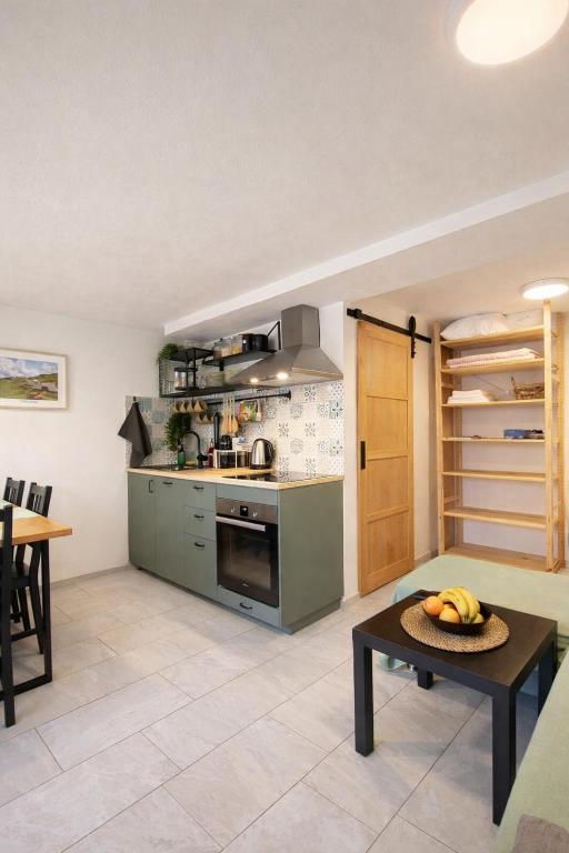a kitchen with a stove and a table at Apartma Licko in Domžale
