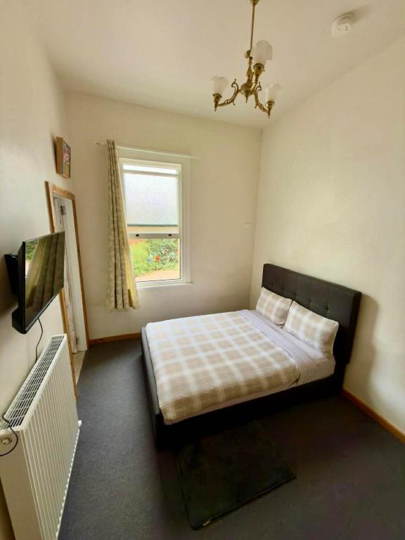 a bedroom with a bed and a window at Royal Hotel Coonabarabran in Coonabarabran