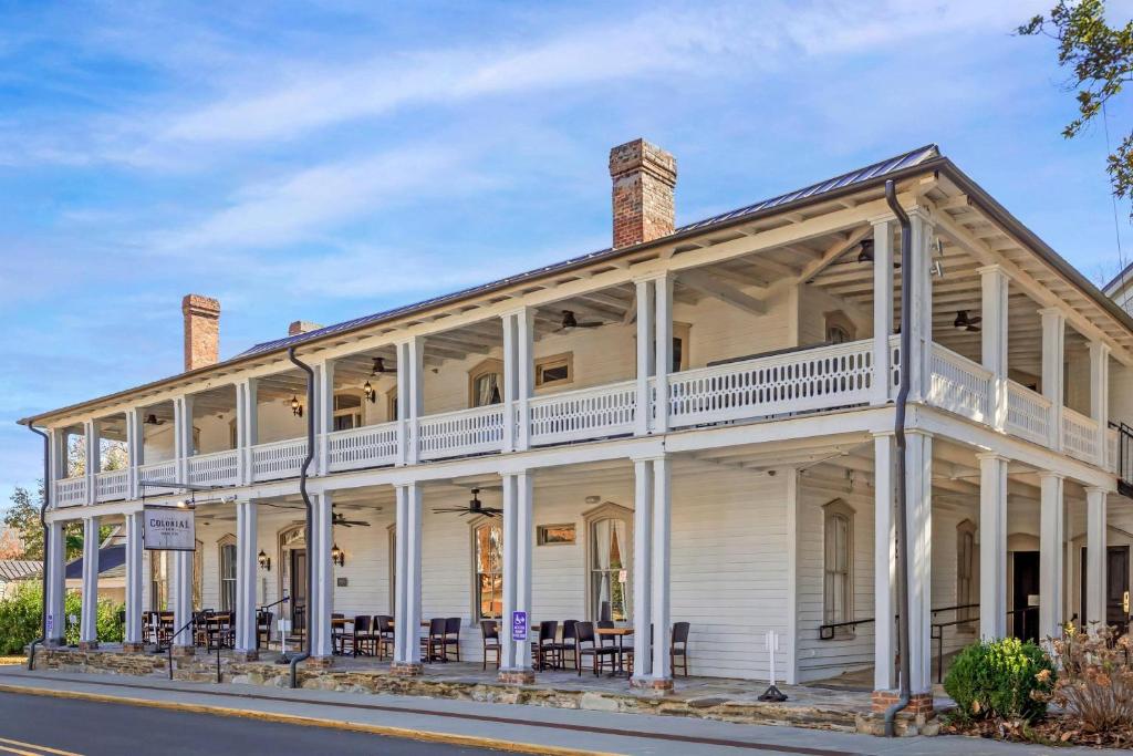 a white house with white columns at The Colonial Inn, an Ascend Collection Hotel in Hillsborough