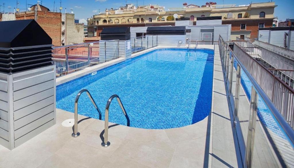 a large swimming pool on top of a building at BCN MONTJUÏC Apartments in Barcelona