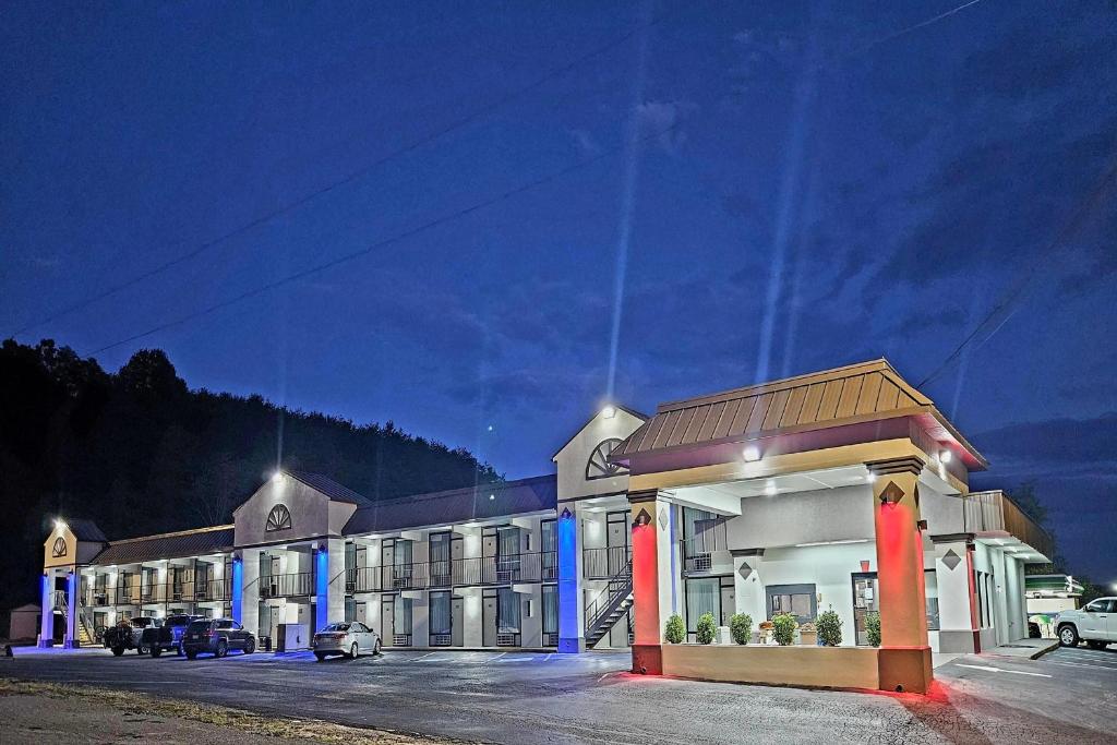 a large building with a gas station at night at Super 8 by Wyndham Marion NC in Marion