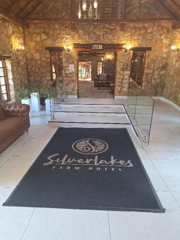 a welcome mat in theoyer of a building at Silverlakes Farm Hotel in Pretoria