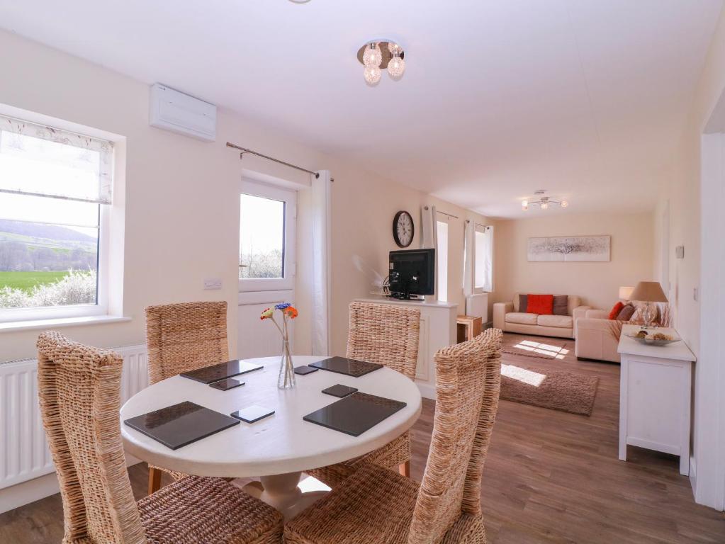 a dining room with a table and chairs at Country Cottage in Brecon