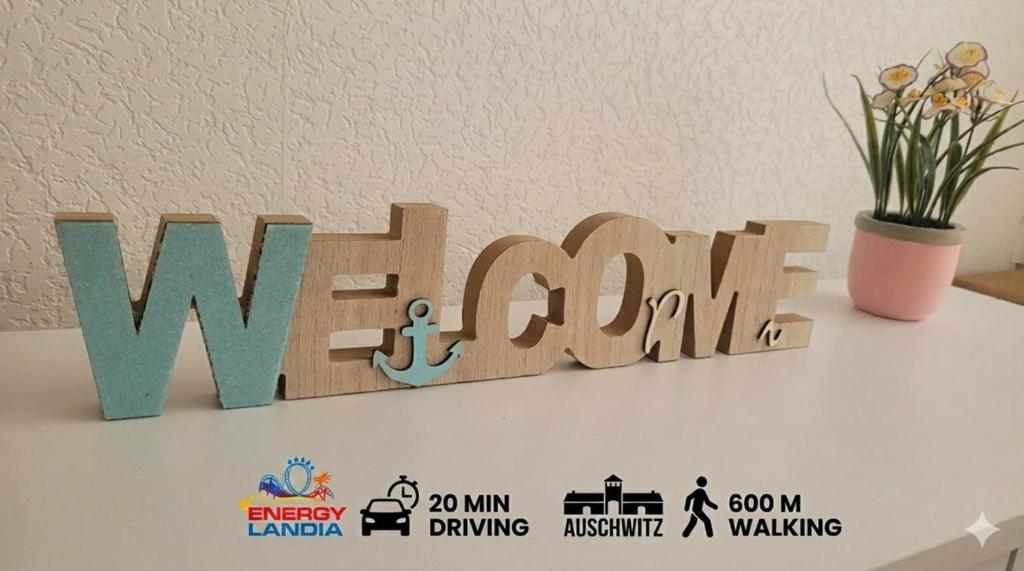 a wooden sign that says wave cut out on a table at DAMS Apartament Oświęcim in Oświęcim