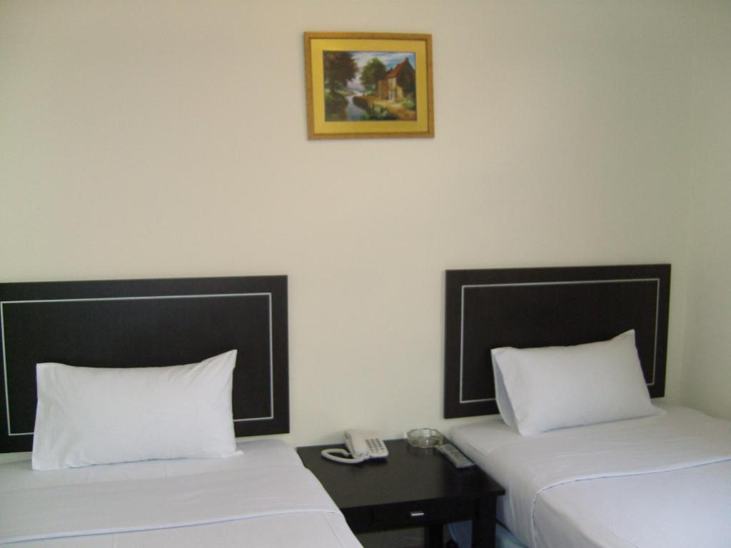 Postel nebo postele na pokoji v ubytování Hotel Orient