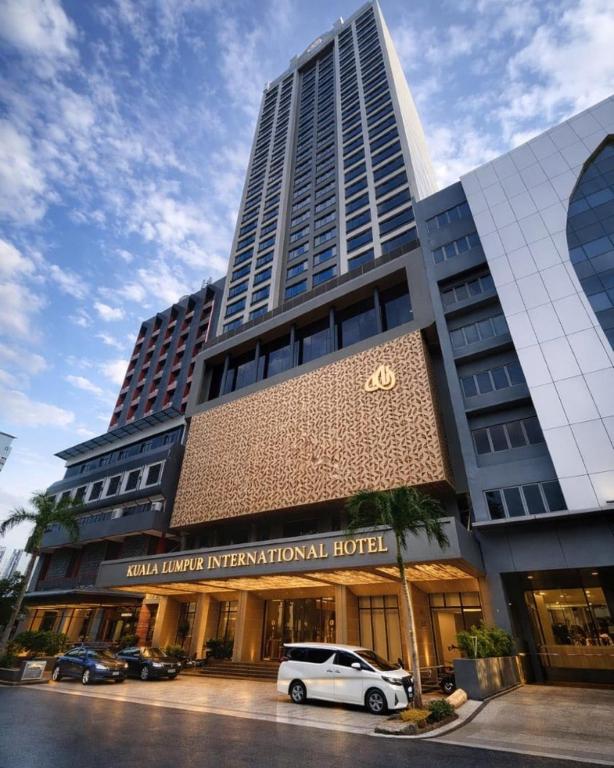 a white car parked in front of a hotel at KL International Hotel in Kuala Lumpur
