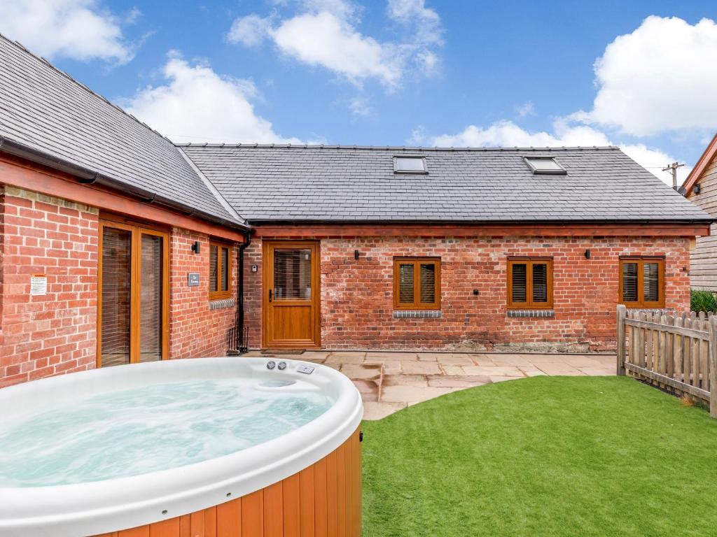 a hot tub in the backyard of a house at The Granary - Uk38980 in Llandyssil