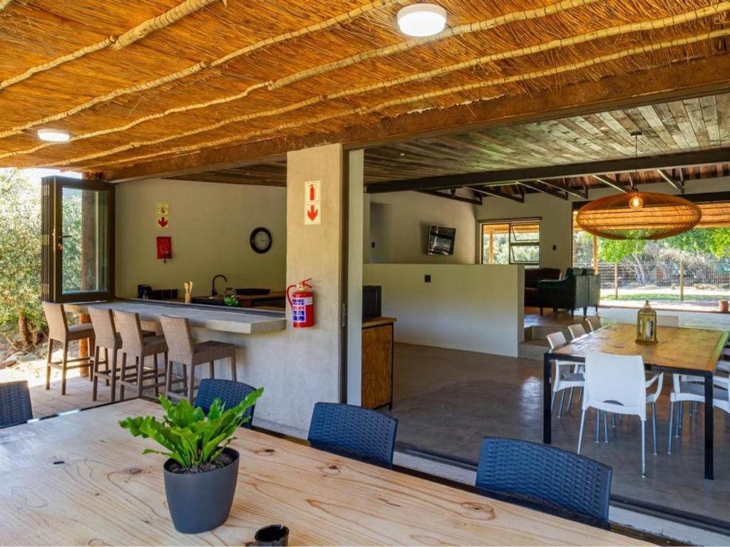 an open kitchen and dining room with a table and chairs at Wild Olive Cottage with Hot tub in Wolseley