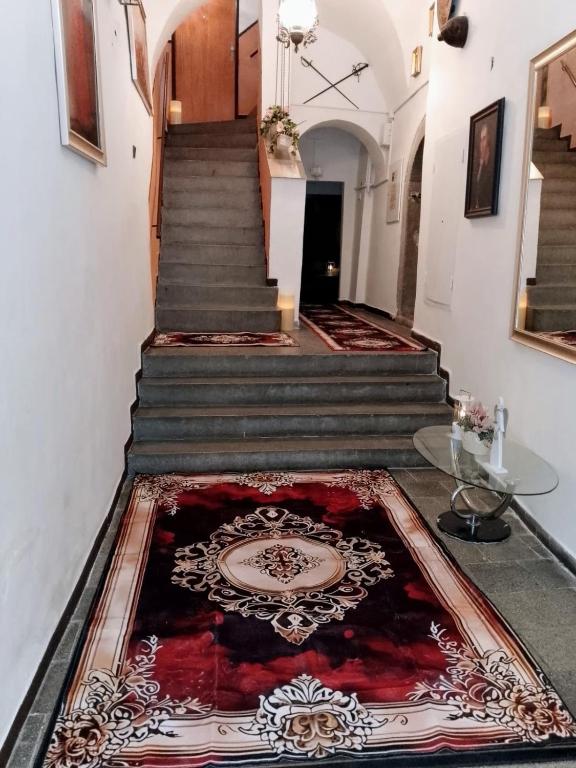 a hallway with stairs with a rug on the floor at Apartman Deluxe Cheb in Cheb