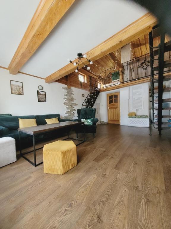 a living room with a couch and a table at Loft Szczytna in Szczytna