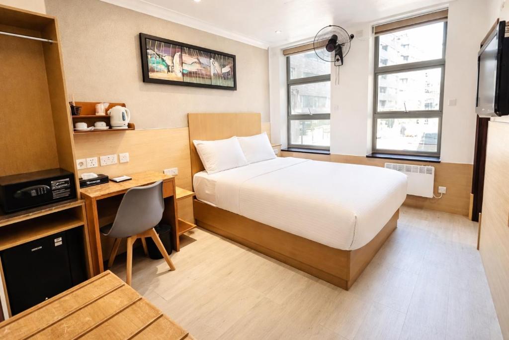 a hotel room with a bed and a desk and a television at Eurotraveller Hotel- Express (Elephant & Castle) in London