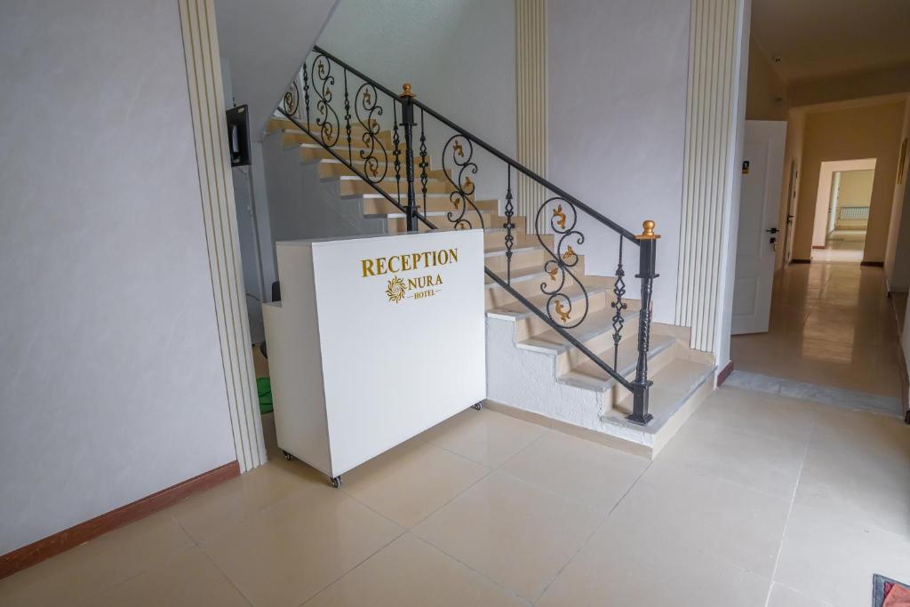 a staircase with a sign that reads repetition stairs at Nura Hotel in Shymkent