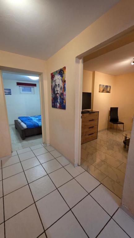 a room with a bedroom with a bed and a television at B&M Apartment in Zierenberg