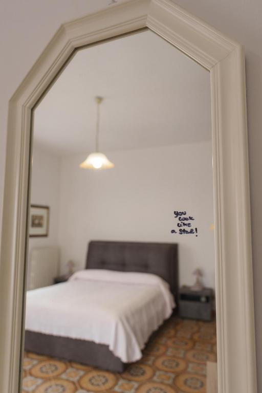 a bedroom with a bed and a large mirror at Casa Dalì in Pianillo