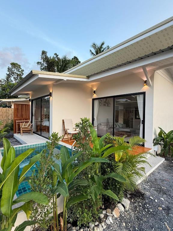 a house with a swimming pool in front of it at Srithanu Escape 2 in Srithanu