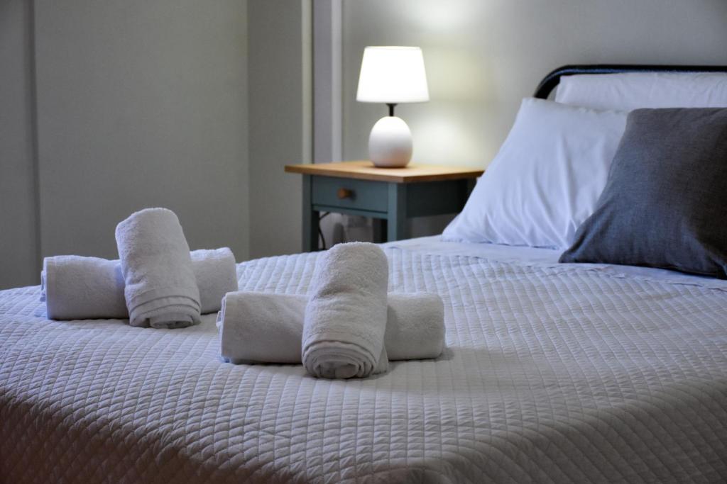 a bedroom with a bed with towels on it at Seaside apartment platana kimis evoia in Kymi