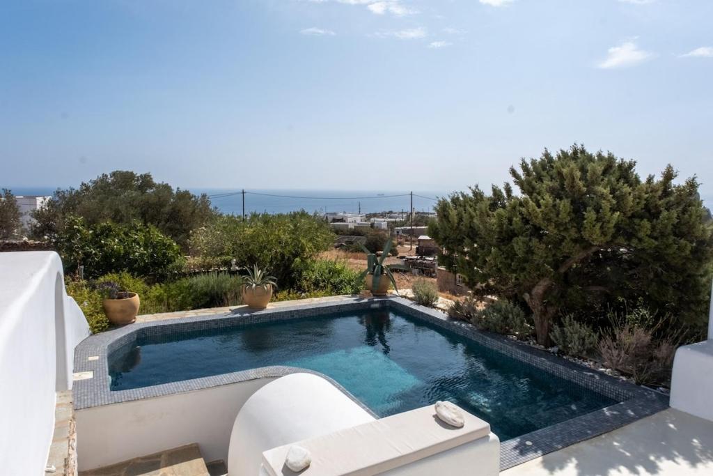 a swimming pool in the backyard of a house at Villa Moon with Private Swimming Pool in Aspro Chorio Paros