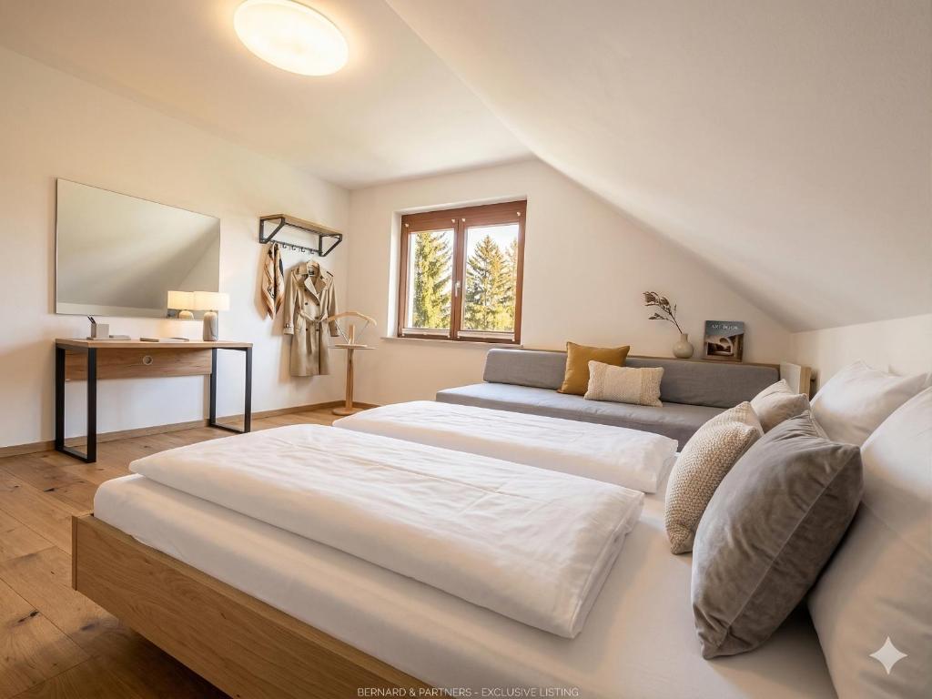a large bedroom with two beds and a couch at W-Apartments - Spacious Parking, EV-Station, Washer & Private Garden in Offenburg