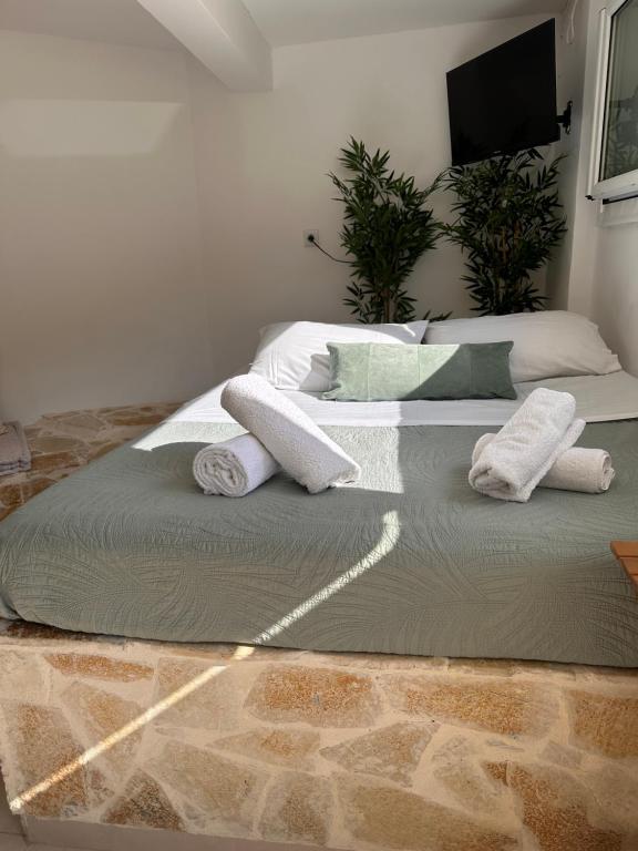 two beds with towels on them in a room at Olive tree studio ,Corfu Town in Ágios Rókkos