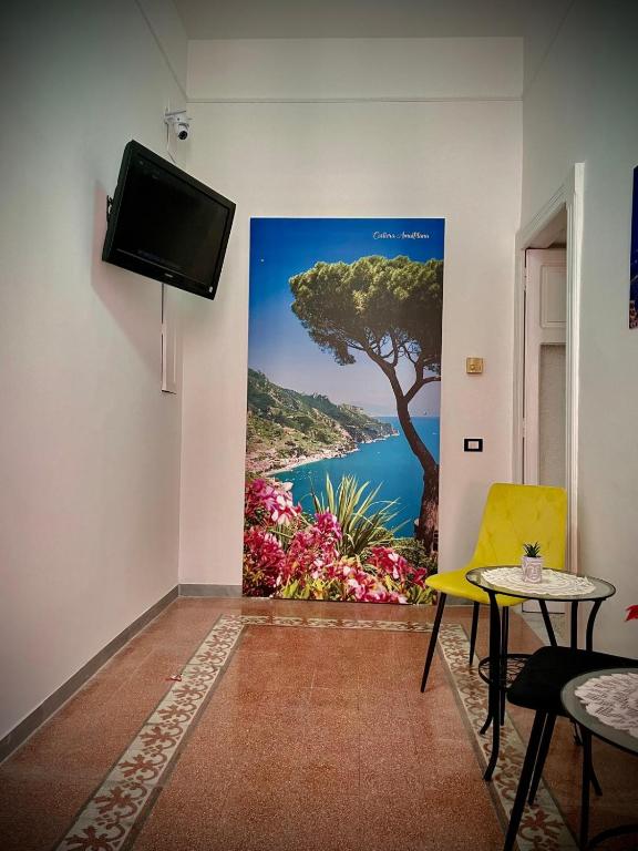 a room with a painting of a tree on the wall at B&B Resto al Sud 2 in Salerno