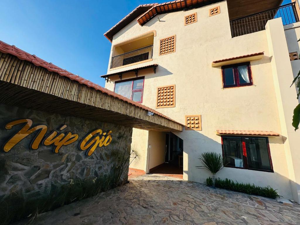 a building with a sign on the side of it at Núp Gió Cottages in Ấp Mỹ Hải