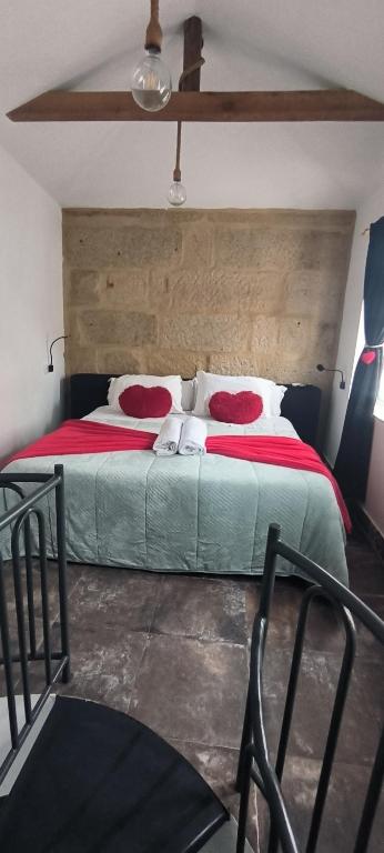 a bedroom with a large bed with red pillows at La casita in Pontevedra