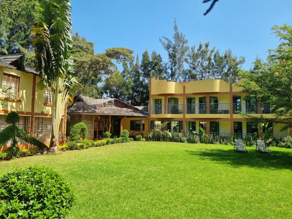 an exterior view of a house with a yard at Karen Little Paradise, ECO Garden Hotel & Farm in Nairobi