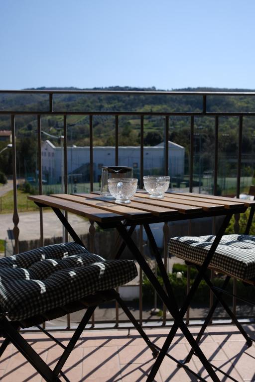 a wooden table and two chairs on a patio at Civico 107 in Capolona
