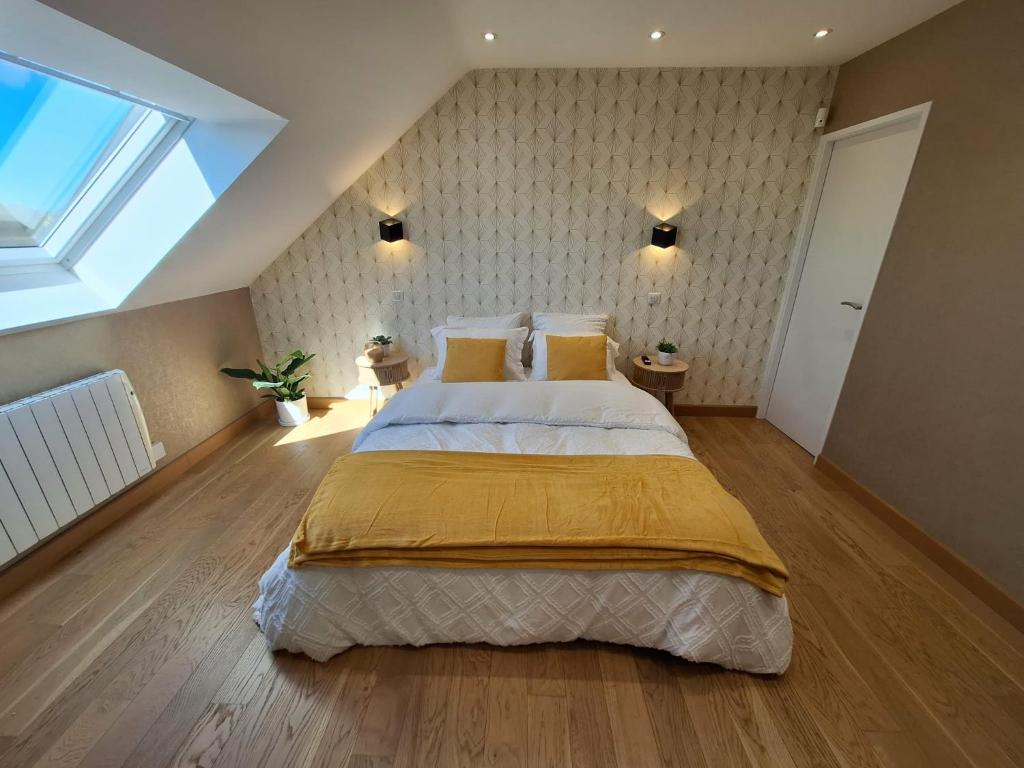 a bedroom with a large bed and a skylight at Le Garage & Spa Gold in Gondreville
