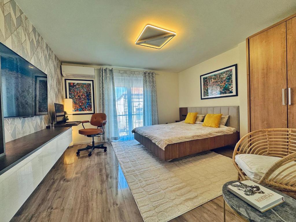 a bedroom with a bed and a living room at Negotin Centar Apartment with Parking in Negotin