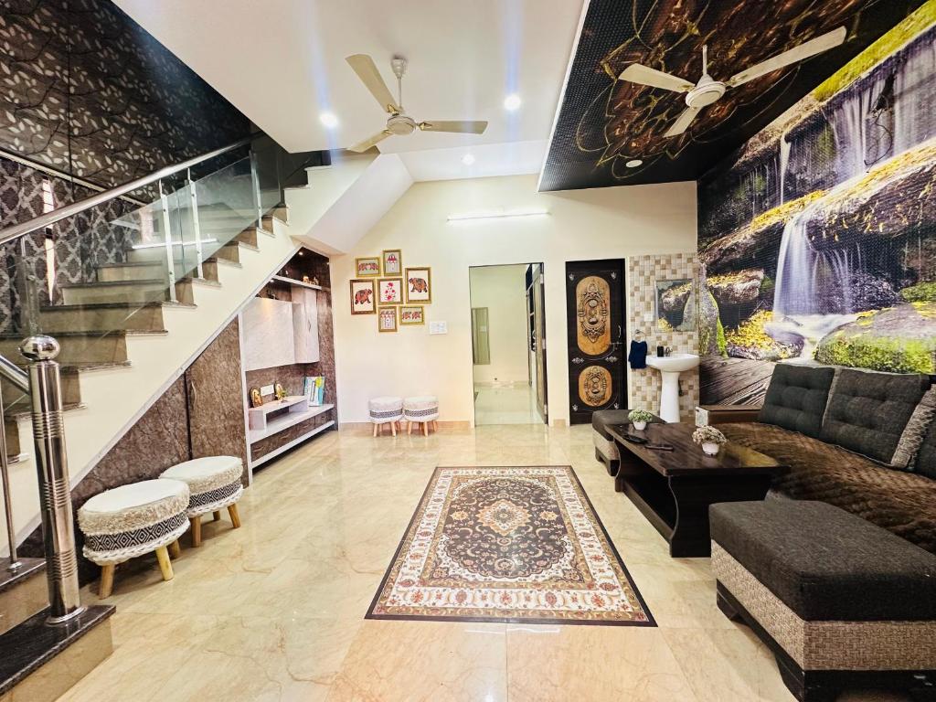 a living room with a couch and a staircase at Nasadra villa in Jaipur