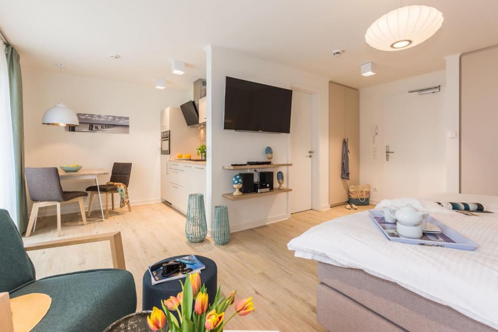 a living room with a couch and a table at Am Park 27 in Prerow