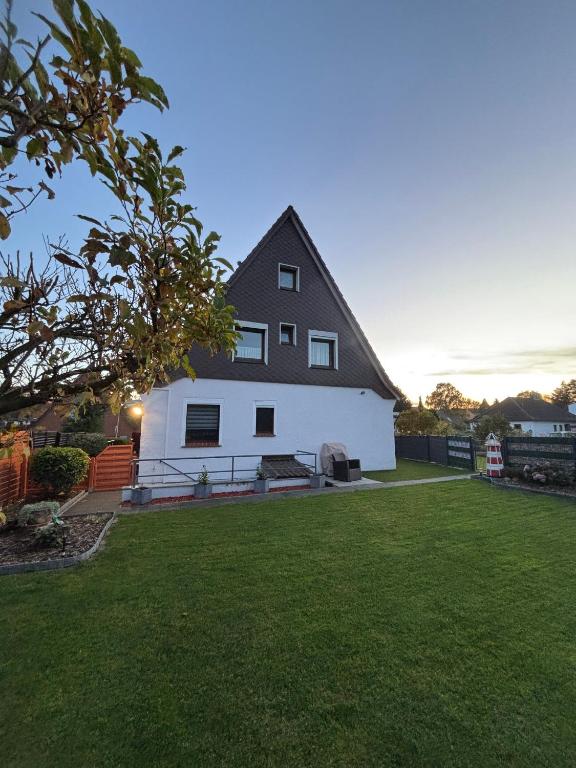 a large white house with a black roof at fewo-brigitte in Buxtehude