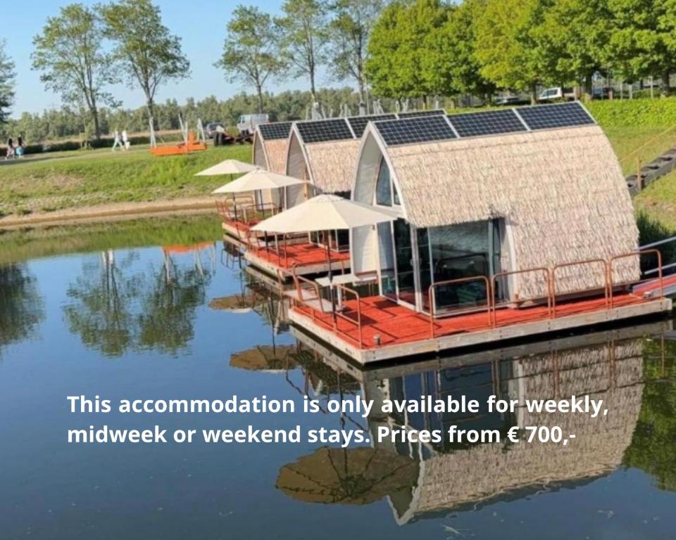 a house on a dock on a body of water at deBieslodge in Drimmelen