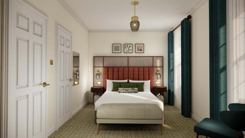 a bedroom with a large white bed and a door at Parade Hotel Bath in Bath