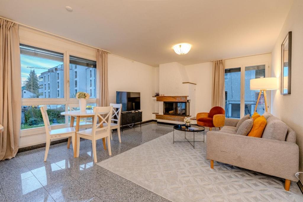 a living room with a couch and a table at Copper Suite · Seebach in Zurich