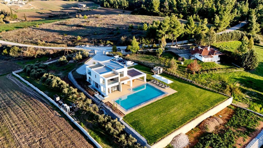 an aerial view of a house with a swimming pool at Sani Chateau in Sani Beach