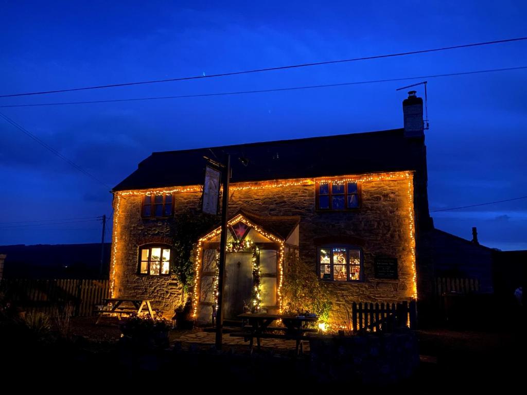 a stone house with lights on it at night at The Stables Inn in Minsterley