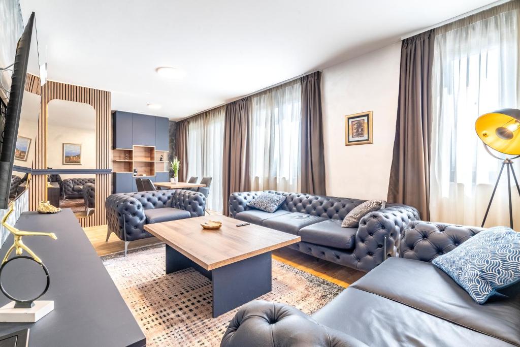 a living room with couches and a table at Arena Lux Apartments in Zagreb